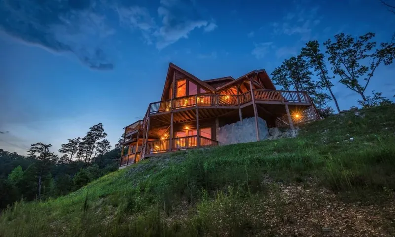The whole cabin seen from below the ridge in the last light